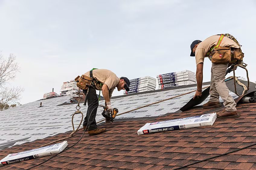 Nexora LLC roofing crew installing shingles on a residential roof